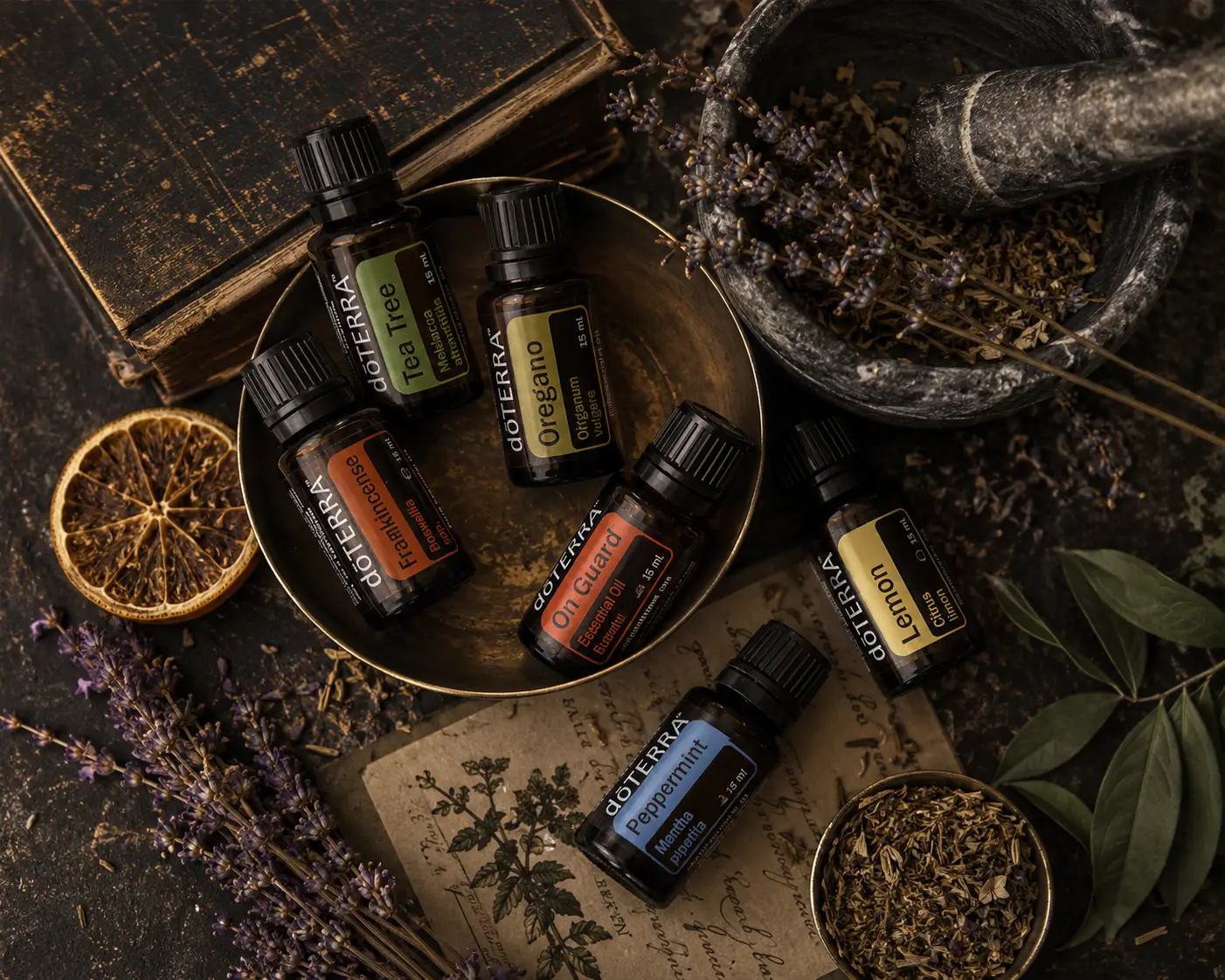 Apothecary still life of dōTERRA essential oils with lavender, citrus, and herbs